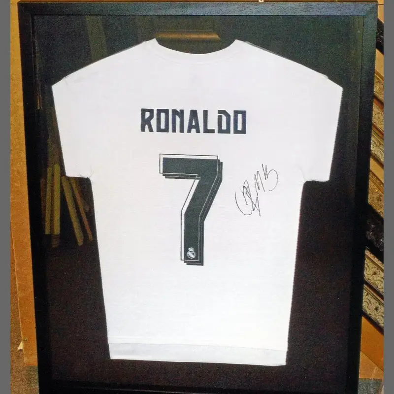Signed football shirt in a black box frame framed by Tripps of Keynsham